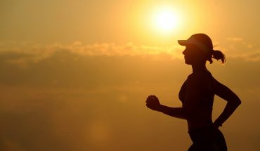 Woman running at sunrise